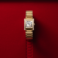 cartier tank watch on red background