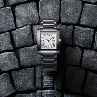 cartier tank watch on gray stone background