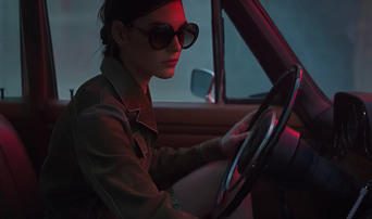 woman driving car while wearing Bottega Veneta sunglasses