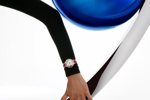 woman's arm wearing ballon bleu watch by cartier